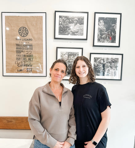 Mother/daughter team Megan and Maddie, posing with San Lazaro Coffee farmers on the wall at Pickering Coffeehouse in Phoenixville, PA