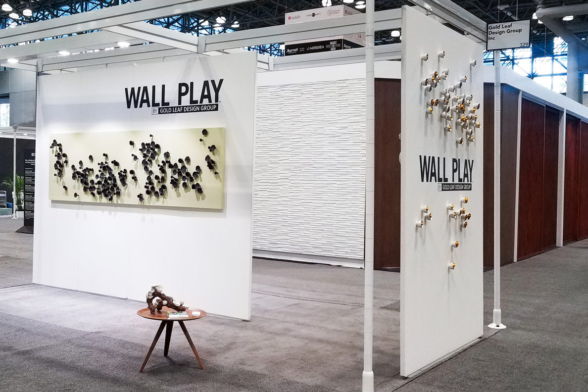 Gold Leaf Design Group's booth at BDNY, white walls with Wall Play sculptures on them.