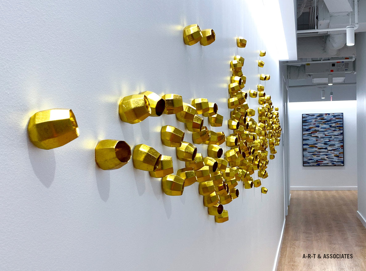 Gold Barnacle Wall Play design on wall in a hallway.