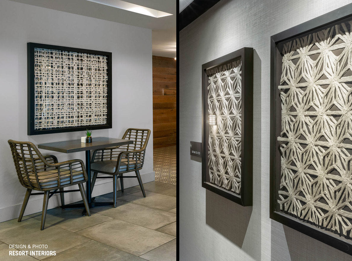 Two images. One of handmade paper in a frame on the wall above a table and two chairs in a cafe. The other is two framed handmade paper artworks in a hotel hallway.