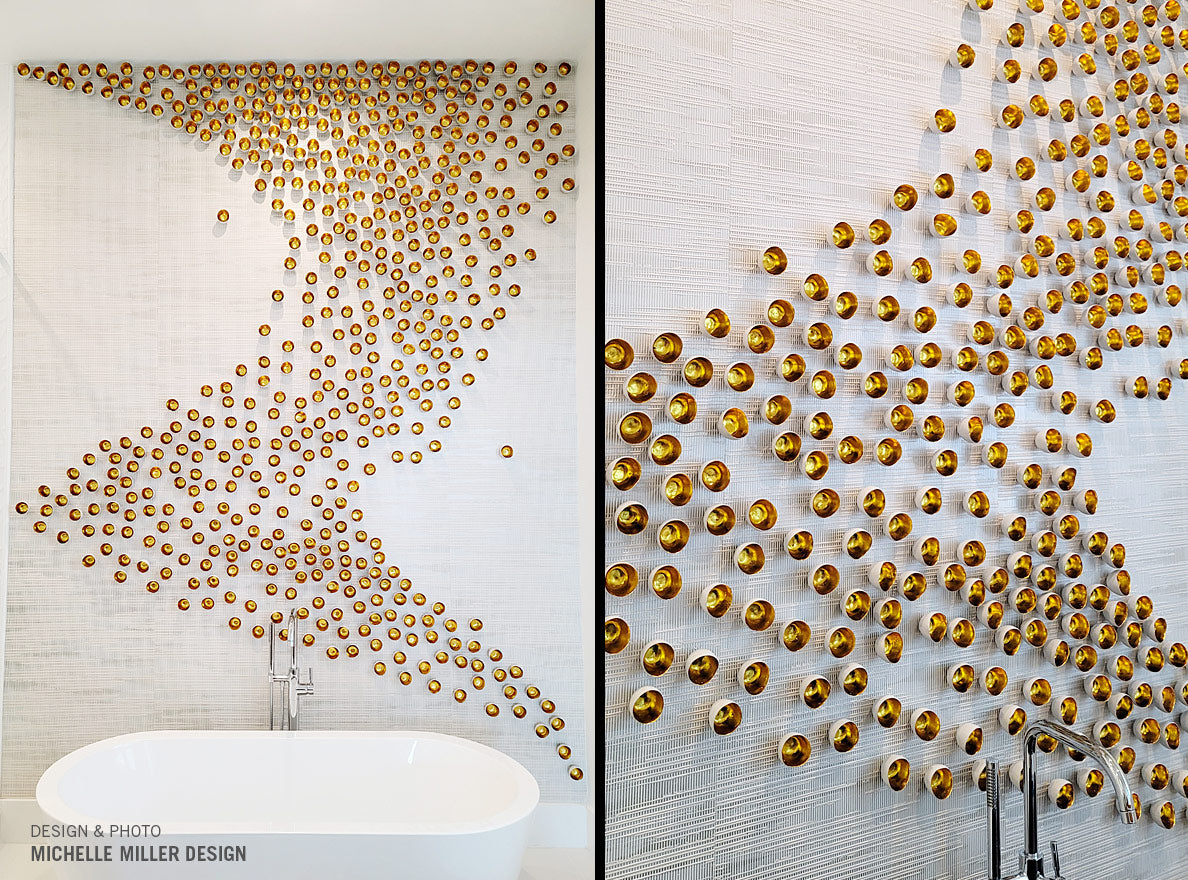 Many Gold Seed Wall Play™ wall sculptures making a wave pattern on a cream textured wall behind a bathtub.