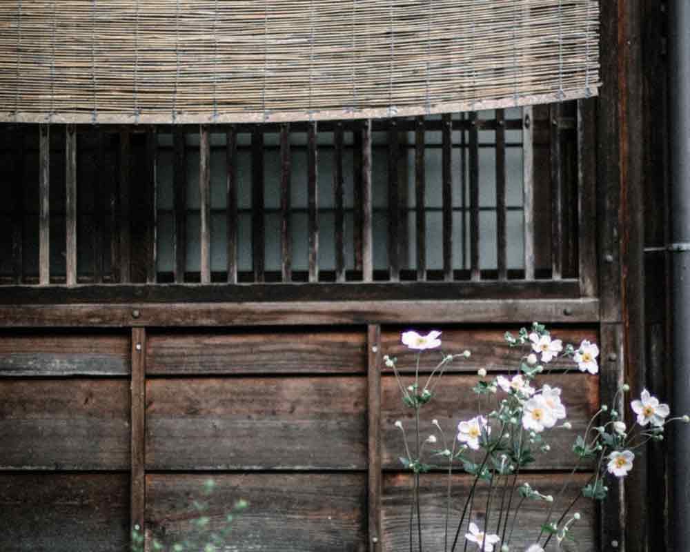 Traditional Japanese house with flowers growing out front