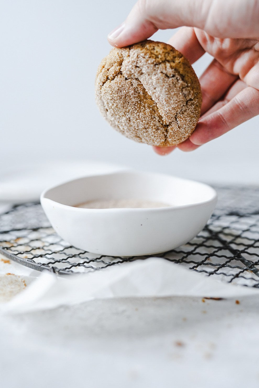 Pumpkin Snickerdoodles dipped in sugar in a handmade pottery bowl