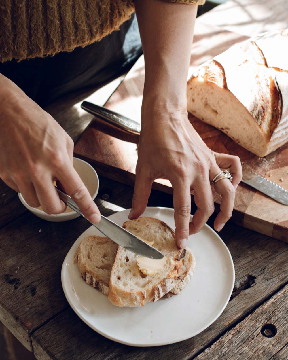 Buttering sourdough at the Slow Drift