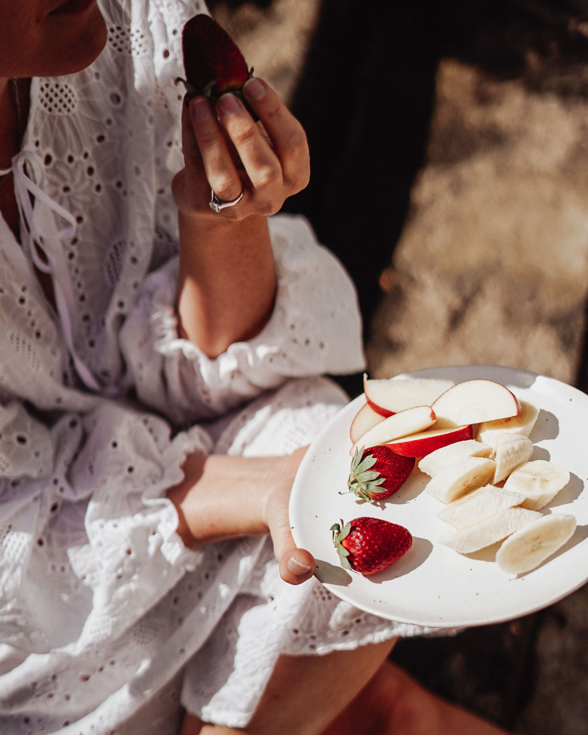 Holding a plate of cut fruit