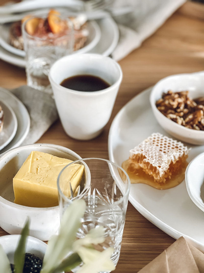 Coffee, bread and butter on a coffee table