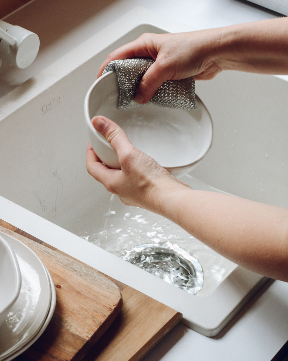  Washing handmade ceramic bowl at Hidden Cabins 