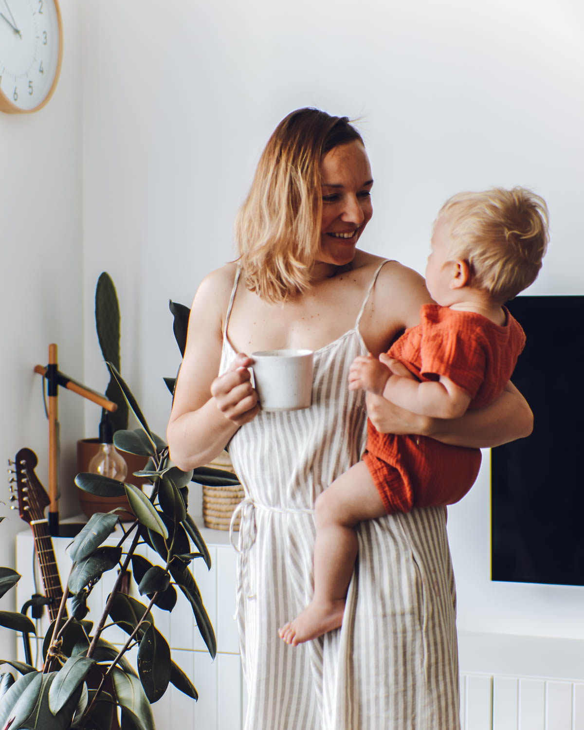 Simona holding her coffee mug and her son