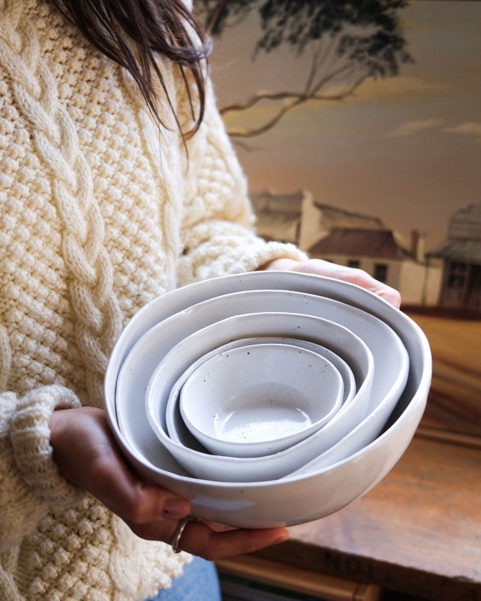 holding a set of bowls