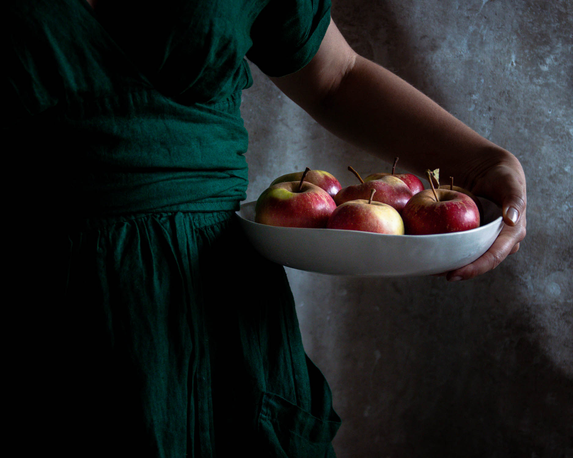 Holding a bowl of freshly picked apples