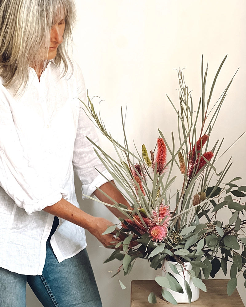 Marion arranging banksia flowers in a Winterwares handmade vase