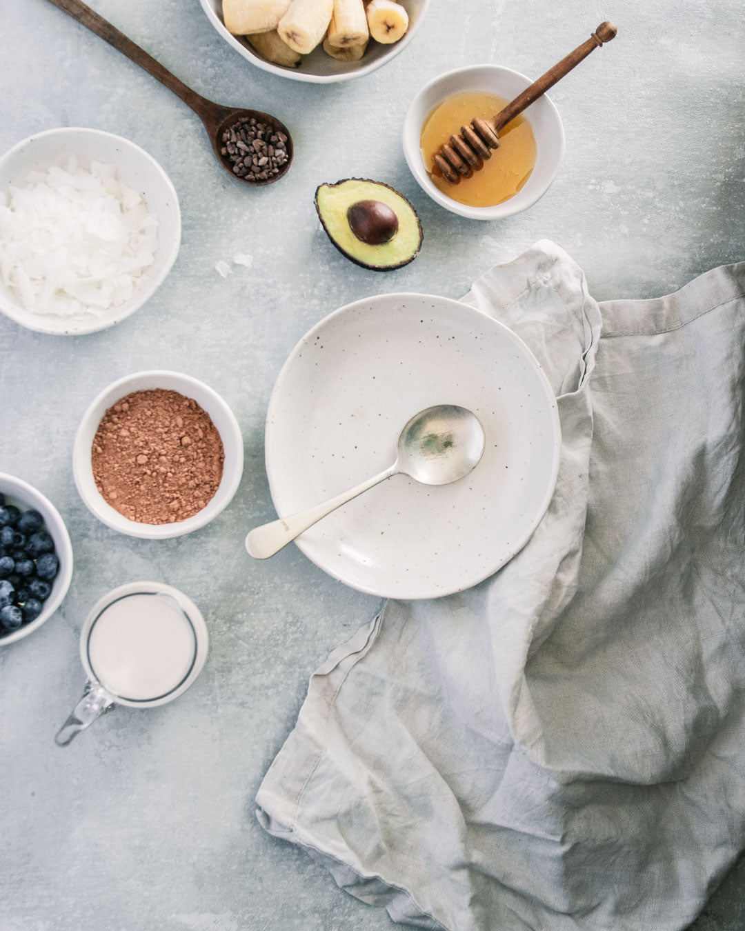 Flat lay of Winterwares ceramics containing the ingredients for a chocolate smoothie bowl