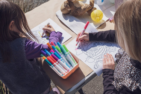 children coloring on an easter themed coloring page