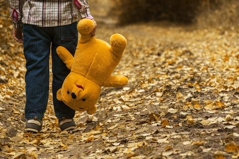 stuffed animal being carried by child