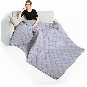 Woman sitting on couch with a weighted blanket