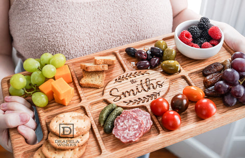 Charcuterie Board being held by person - engraved with "The Smiths"