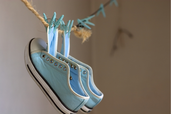 clean blue tennis shoes hanging on a clothesline