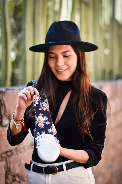 Woman placing rose sock liner into white flat