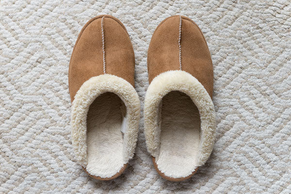 Brown suede slippers with white sheepskin insoles