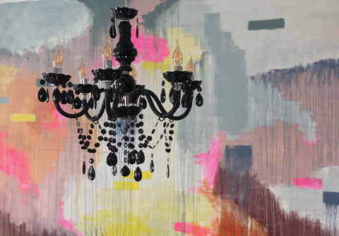 black chandelier on colourful wall background