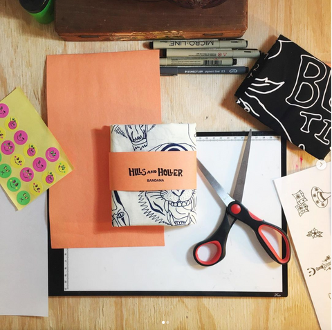 Hills And Holler crafting station. Scissors and paper on display with a HillsAndHoller branded bandana