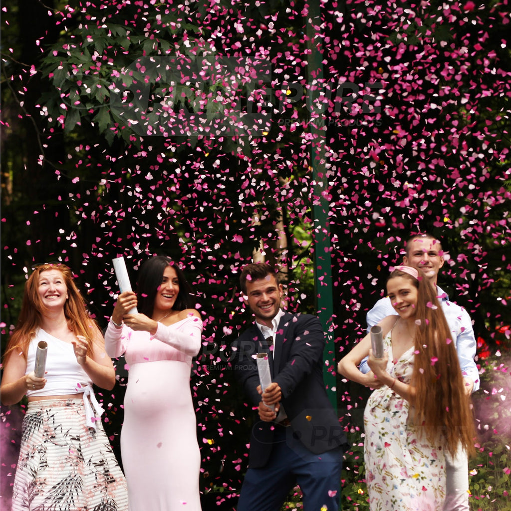 Group of people popped a PINK confetti cannons