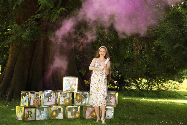 A mother popped a PINK powder cannon with a custom letter boxes decorated