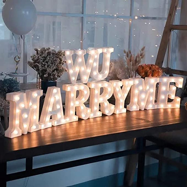 Marquee letters 'W U MARRY ME' lights