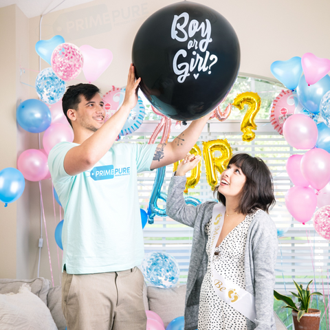 A couple and their gender reveal decorations