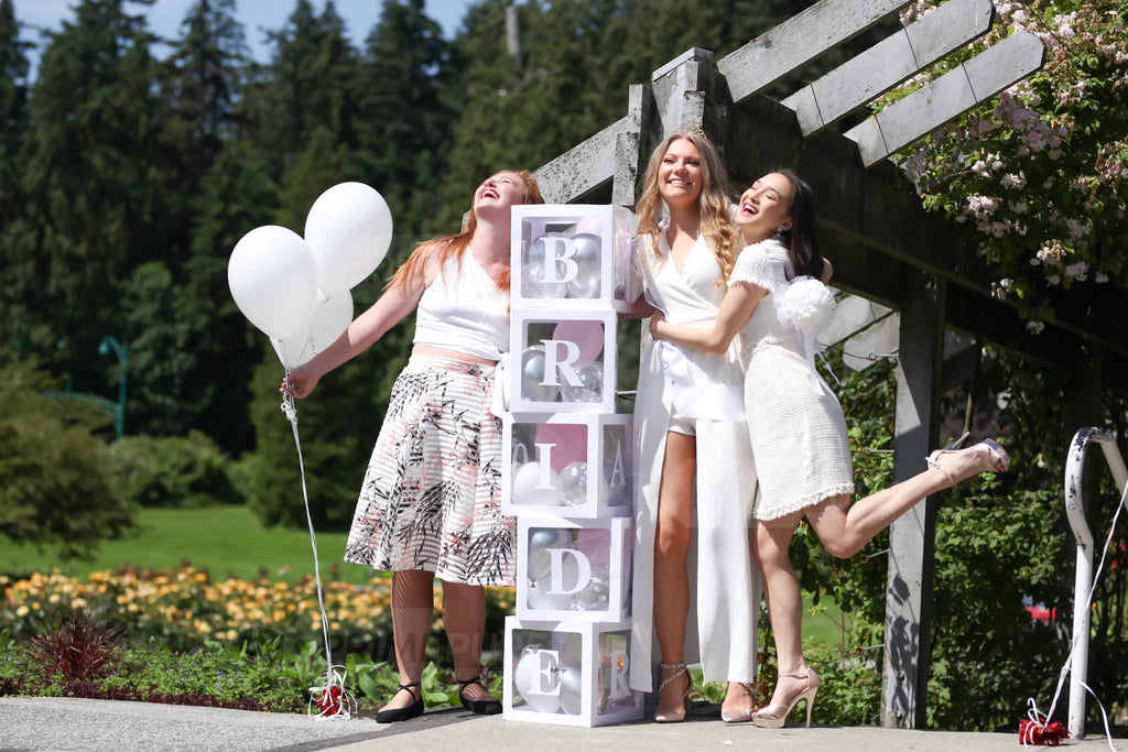 3 girls with a custom letter "BRIDE" boxes decorations