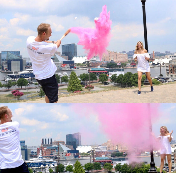 Parents popped a ball that has pink powder using a baseball for their Baby's gender reveal