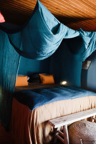 Los Emorandos Hotel Bedroom, with blue bedding and ceiling sails