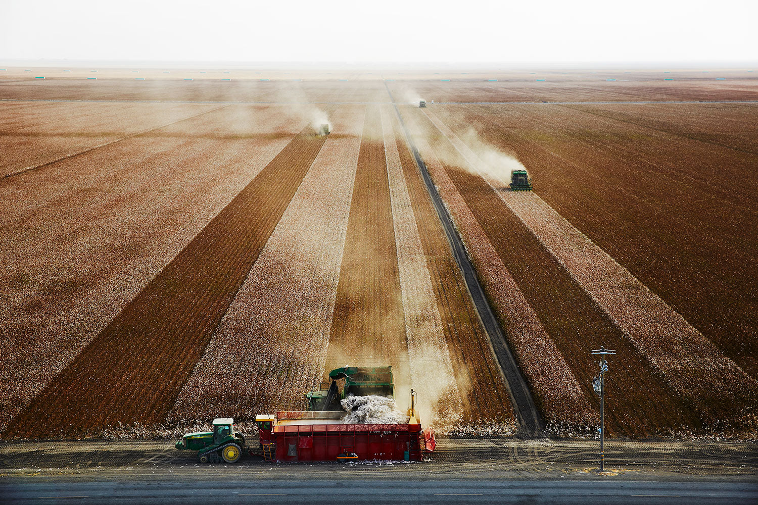 Trackers harvesting the Supima cotton farm field. With use of GPS technology to ensure the wheels stick to the same track.