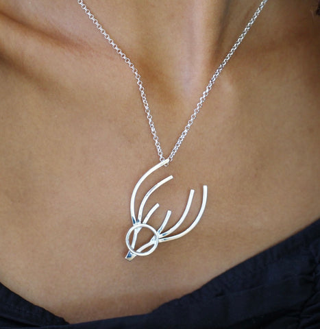 stag pendant in silver hangs at an angle is handmade and designed in Ireland by female goldsmith