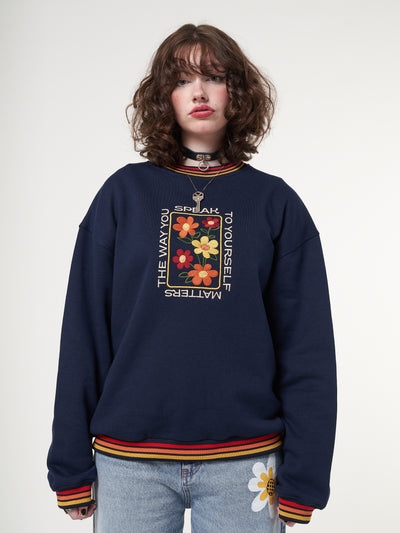Sweatshirt in navy blue with colourful flowers front embroidery and rainbow striped rib neckline, cuffs and hem