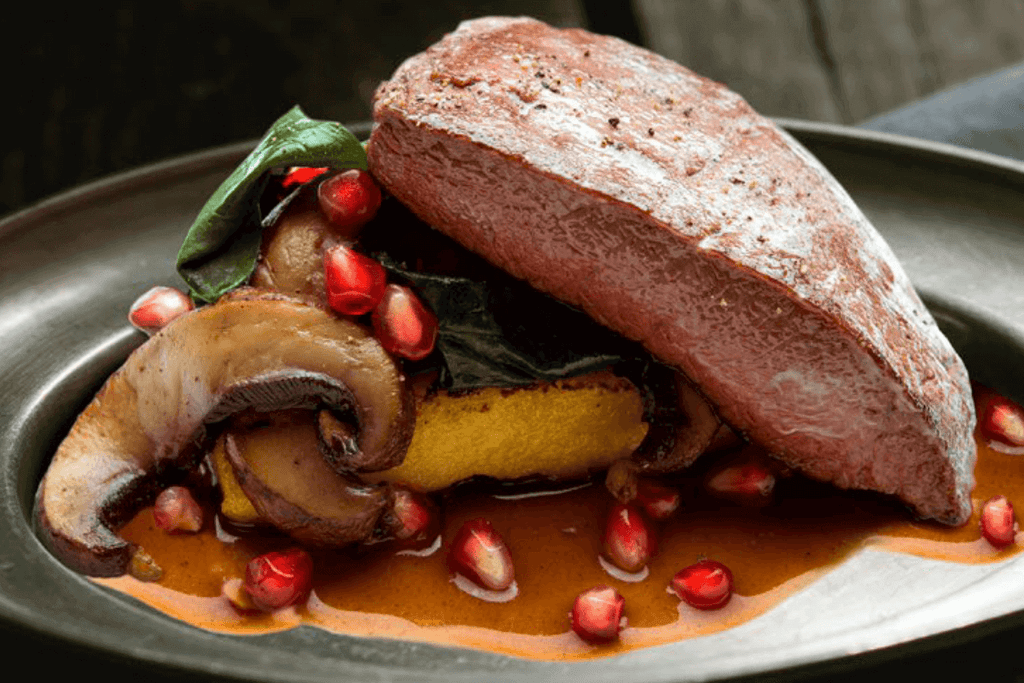 Australian Oyster Blade Steak with Polenta, Portobello Mushrooms, Wilted Greens and Pomegranate Balsamic Vinaigrette - Halalia