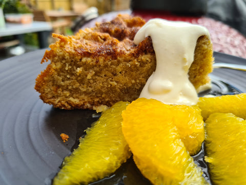 Served plate of Spiced Orange cake with boozy oranges and cream