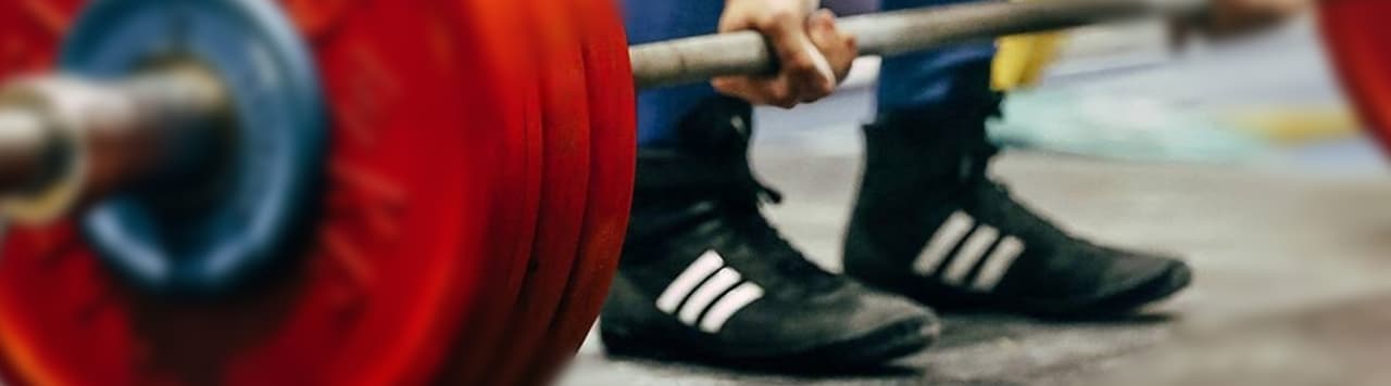 male athlete performing a deadlift wearing Adidas Havoc Deadlift Boots