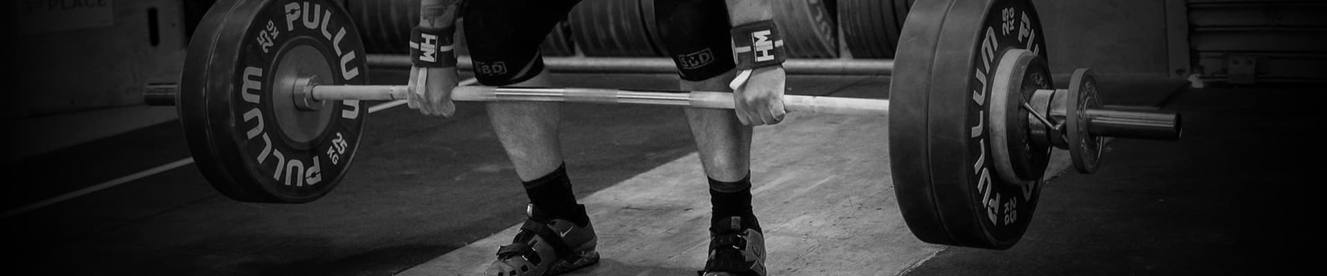 Deadlift being performed with Pullum discs loaded onto a barbell