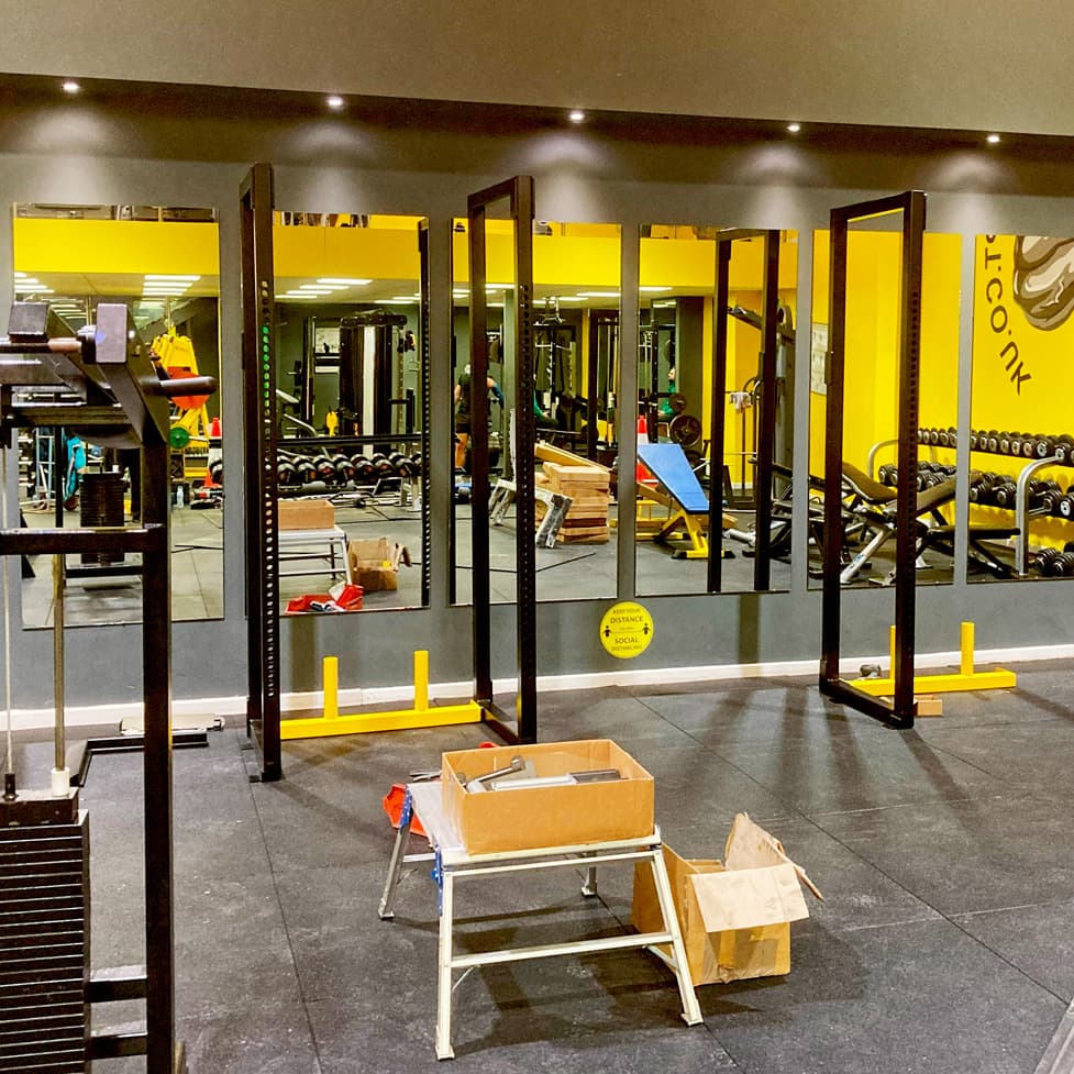 Commercial gym flooring with back to wall racks semi built