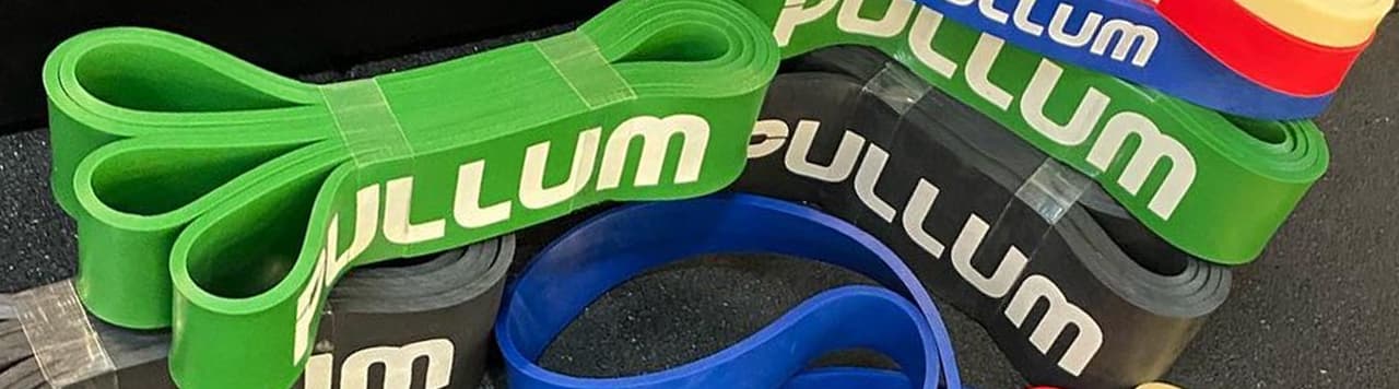 A variety of Pullum resistance bands on a gym floor