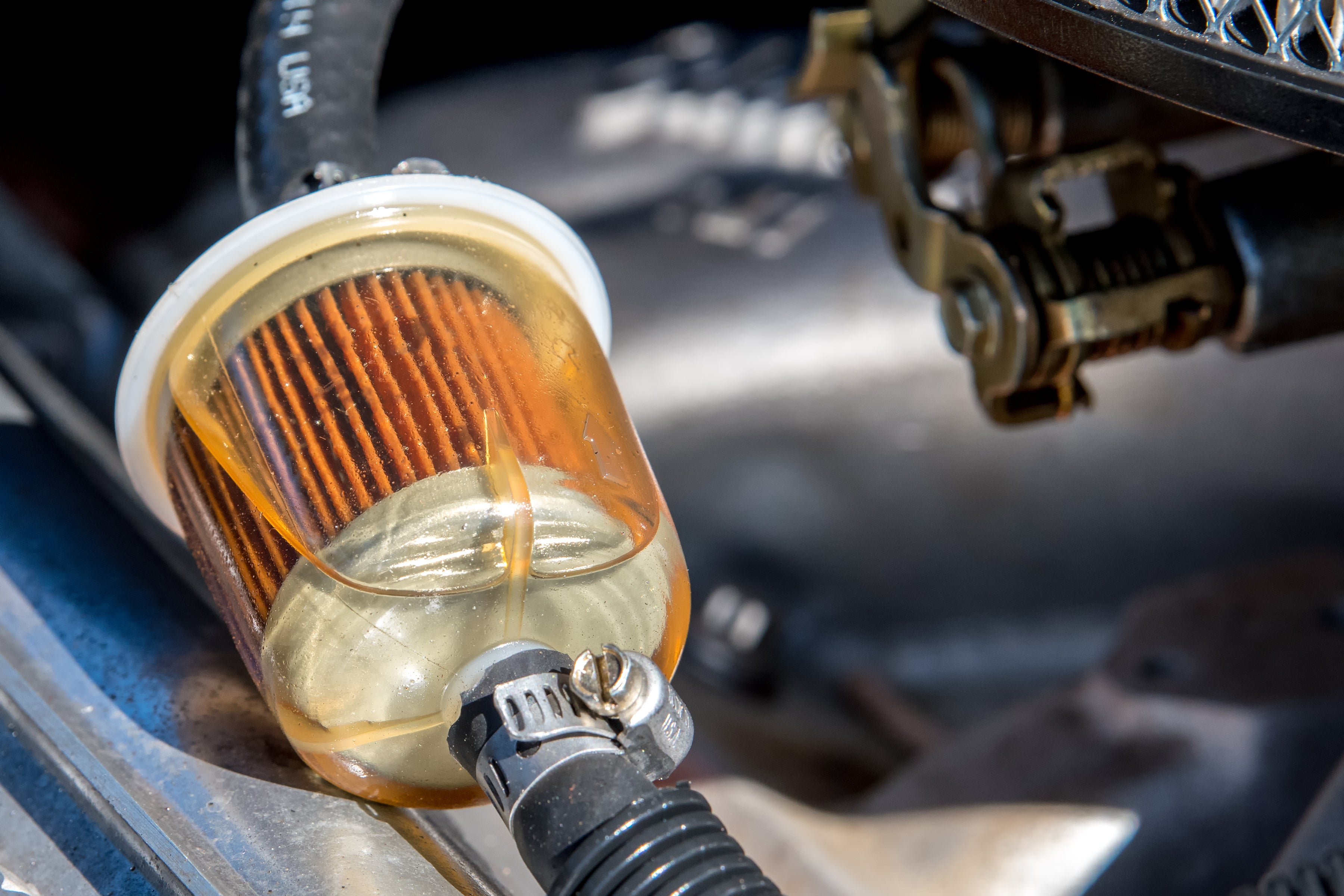 A fuel filter in a car. Gasoline can be seen in the filter.