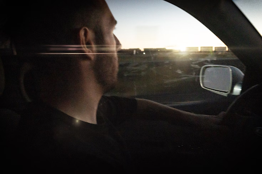 Man driving with JJ Abrams style lens flare after fixing PCM issues with scanner tool.