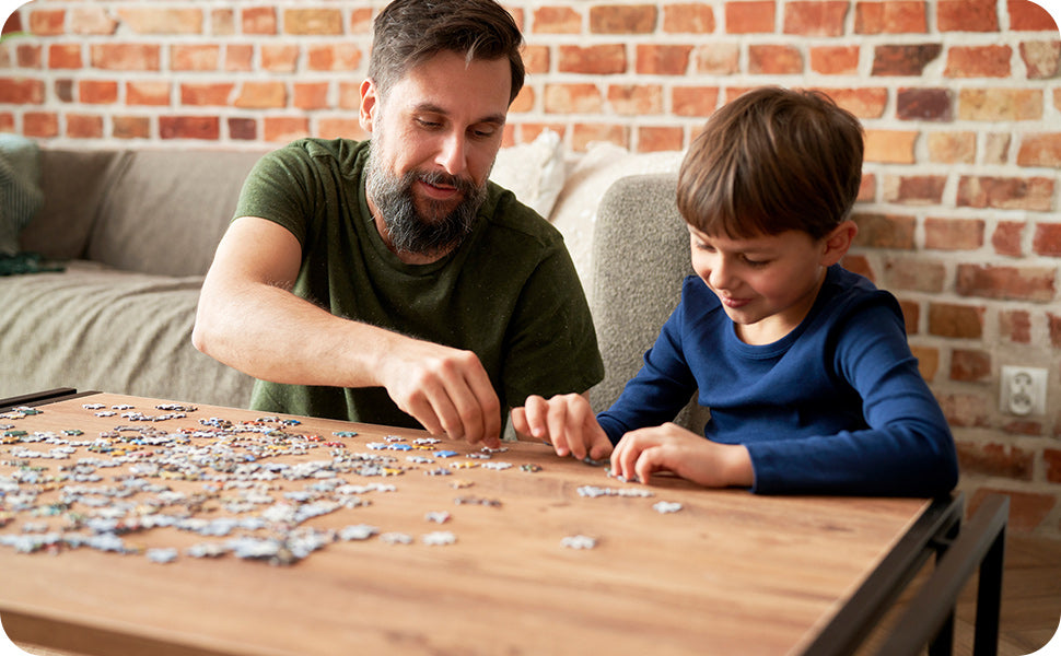 toddler boy working on a puzzle with dad