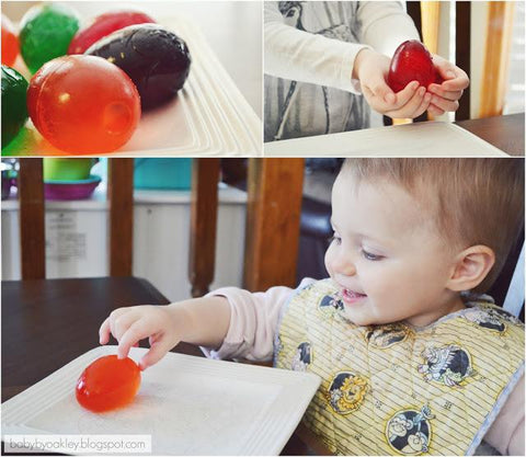 Colorful Easter eggs and child in high chair