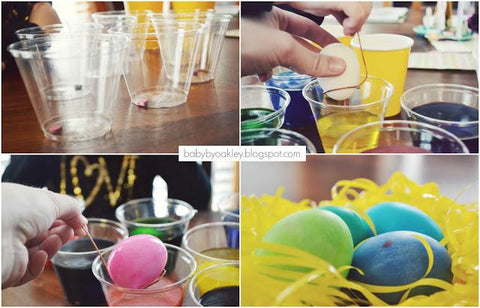 child's hands dyeing Easter eggs