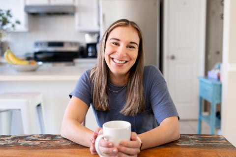 Jessica Irwin, potty training expert, sitting at a table with coffee in her hands