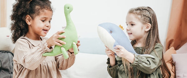 image of girls playing with stuffed animals