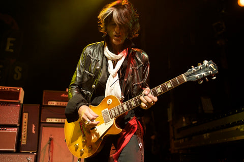 Joe Perry of Aerosmith hanging his Gibson Les Paul with his Red Monkey guitar strap.