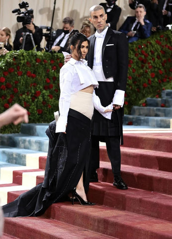 Kourtney Kardashian and Travis Baker's Met Gala 2022 look on the red carpet.